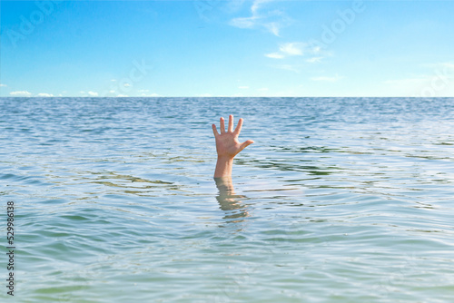 man is drowning, his hand is sticking out of the water