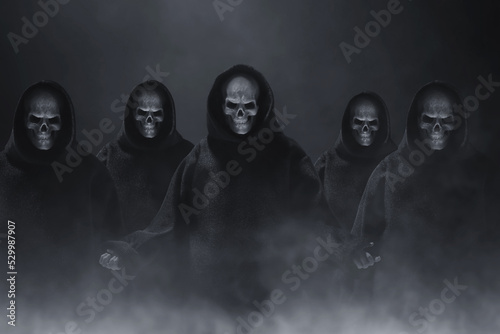 Group of skull hooded on dark background