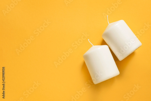 Candles on yellow background
