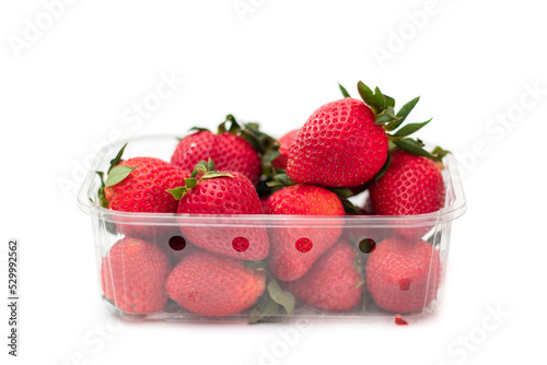 Fresh strawberries in plastic box, isolated on white. Produce product of agriculture industry