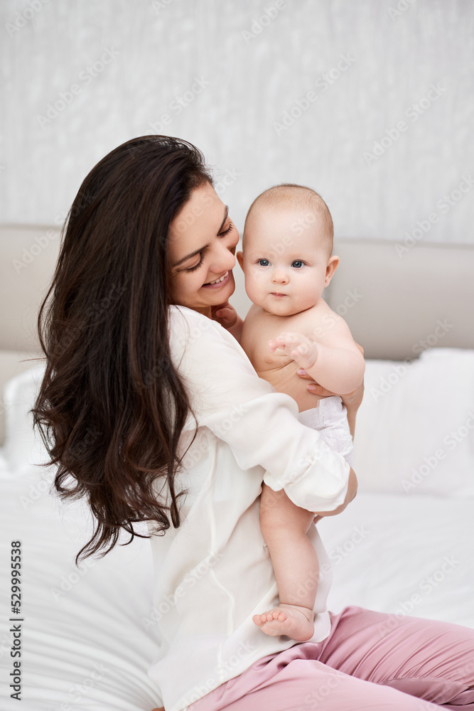 mother plays with her baby girl in the bedroom. mother plays with her baby girl in the bedroom.