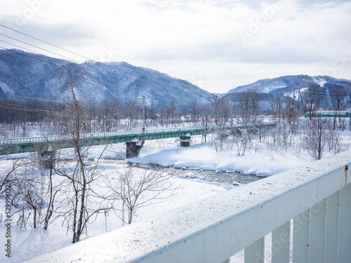 bridge on the snow-covered river in winter nagano