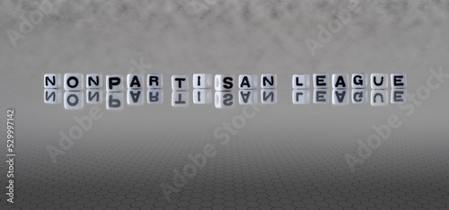 nonpartisan league word or concept represented by black and white letter cubes on a grey horizon background stretching to infinity photo