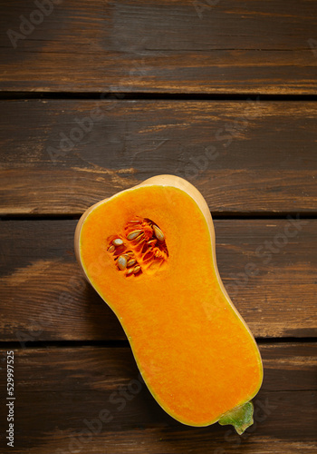 Fresh butternut squash on wooden background. Healthy food concept.