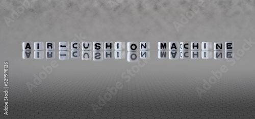 air cushion machine word or concept represented by black and white letter cubes on a grey horizon background stretching to infinity