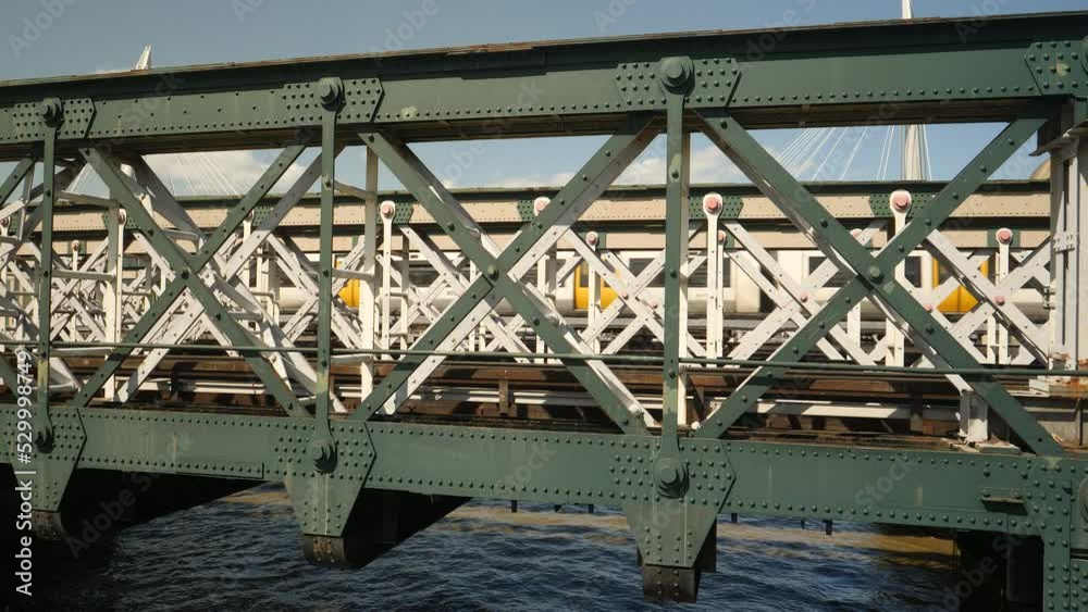 Steel train bridge over Thames river in London with train passing. Close up. Steel train bridge over Thames river in London with train passing. Close up.
