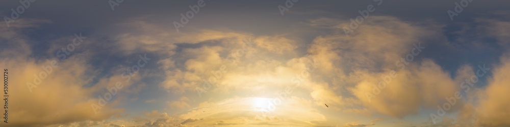 Golden glowing sunset sky panorama with Cirrus clouds. Hdr seamless spherical equirectangular 360 panorama. Sky dome or zenith for 3D visualization and sky replacement for aerial drone 360 panoramas.