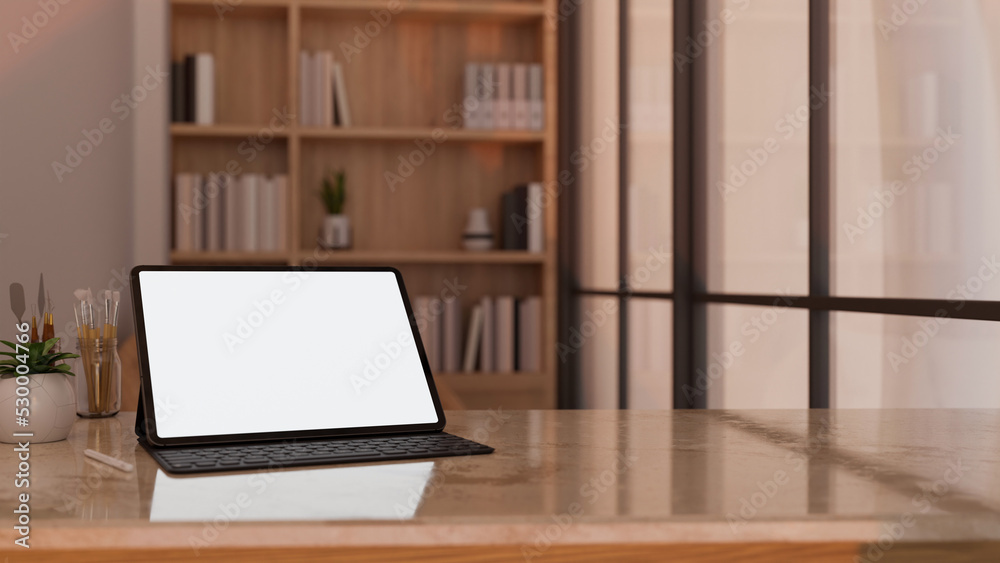 Portable tablet mockup on modern marble tabletop workspace over blurred home working room Portable tablet mockup on modern marble tabletop workspace over blurred home working room