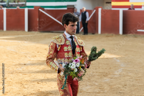 Male matadore with flowers on arena