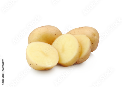 Raw potatoes whole and sliced close up isolated on white background