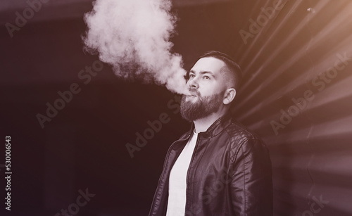 handsome man in a vaping an electronic cigarette