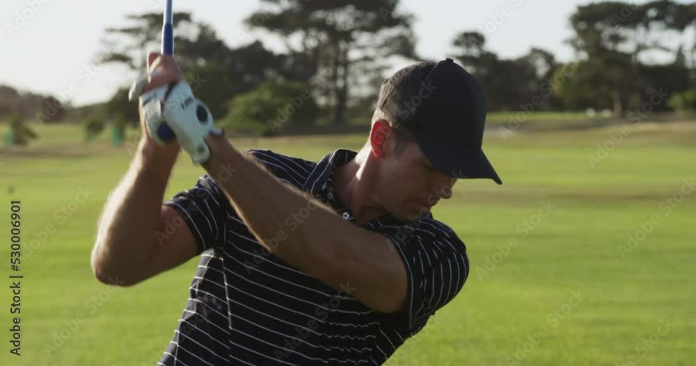 Golf player hitting the ball with his club Golf player hitting the ball with his club