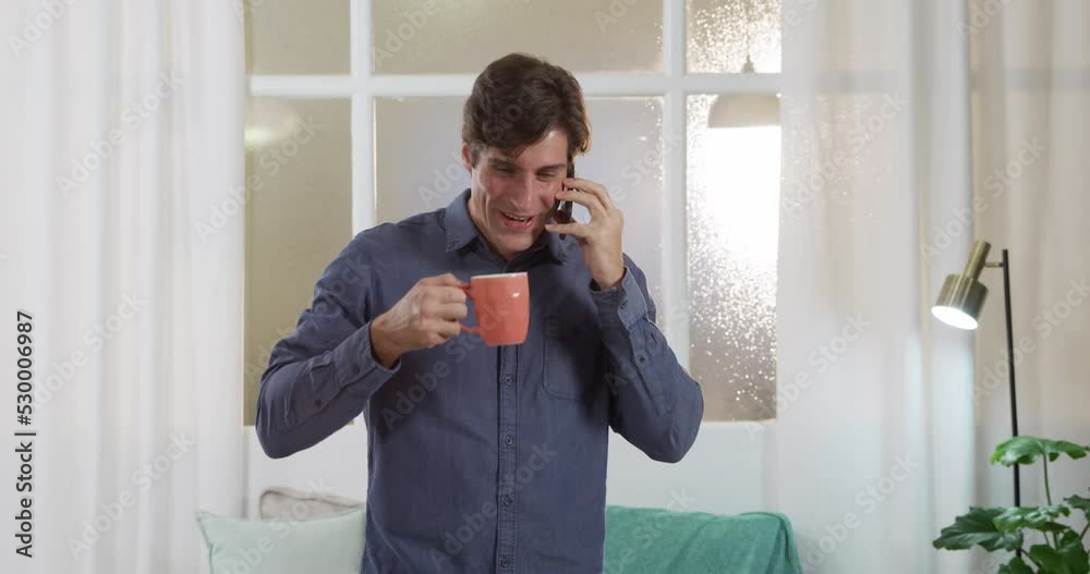 Caucasian man using his phone and drinking coffee Caucasian man using his phone and drinking coffee