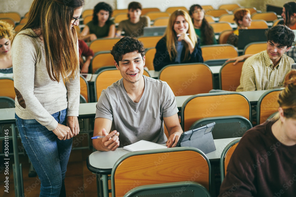 Fototapeta premium Mature teacher working with students inside classroom at school university - Focus on left guy face