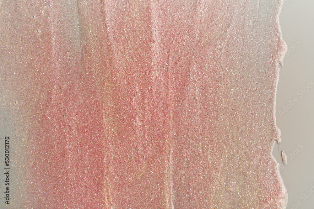 Fototapeta premium Beauty gel texture with pink and golden particles. Shining highlighter background with brush strokes
