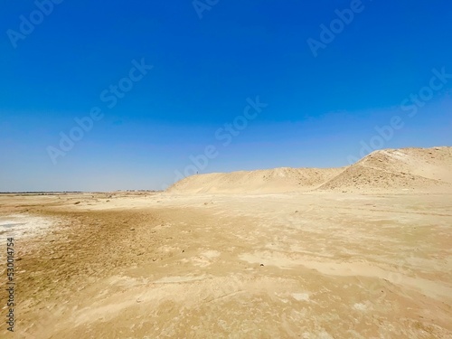 sand dunes in the desert with person on top