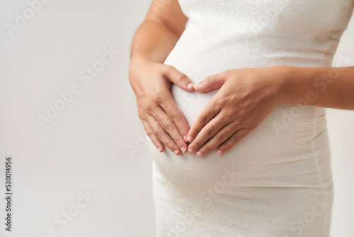 Wallpaper Mural the hands of a pregnant woman forming a heart on her belly Torontodigital.ca