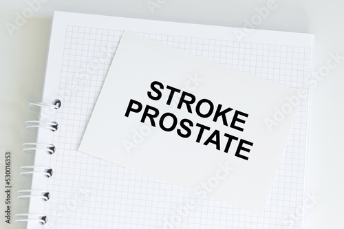 Stroke prostate text on the card that is on a white notepad on the table