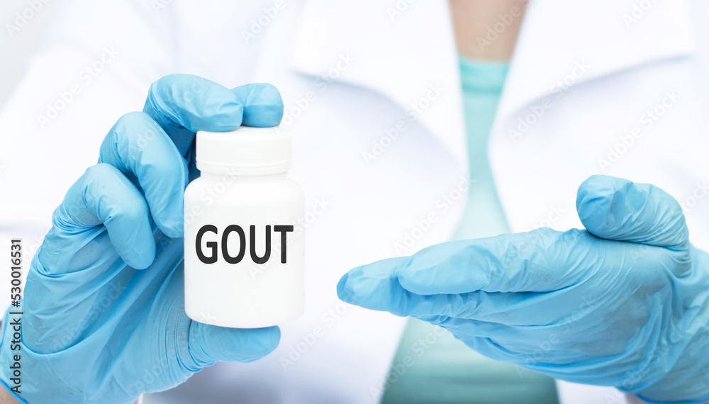 Gout text on the label of a white can in the doctor's hand, a medical concept Gout text on the label of a white can in the doctor's hand, a medical concept