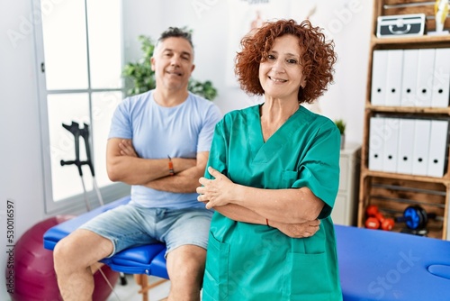 Physiotherapy woman working at pain recovery clinic with patient happy face smiling with crossed arms looking at the camera. positive person.