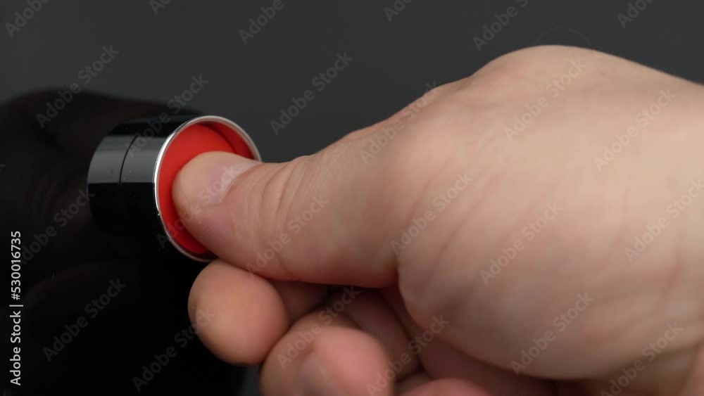 Hand turns the key and press red button, rocket launch or weapon fire concept
