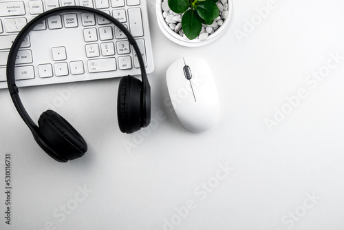 top view of modern white table with headset and computer keyboard on white background call center workspace concept, customer service, online meeting, workspace management style business design space