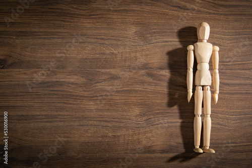Wooden human figure on the table.