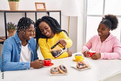 African american friends having breakfast sitting on table at home