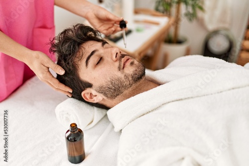 Man reciving skin face treatment at beauty center. photo