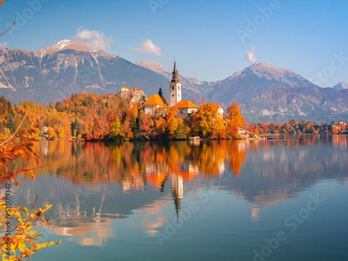 Fototapeta Naklejka Na Ścianę i Meble -  Beautiful church on a small island in the middle of lake Bled in autumn colors