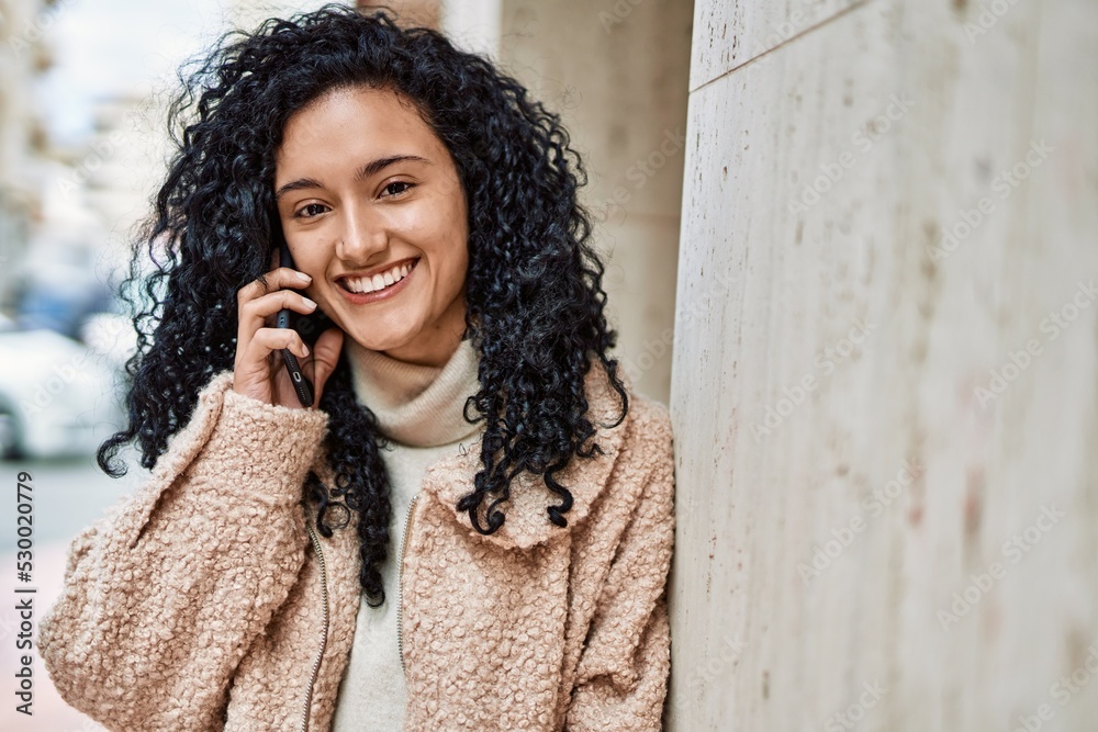 Young hispanic woman smiling confident talking on the smartphone at street Young hispanic woman smiling confident talking on the smartphone at street