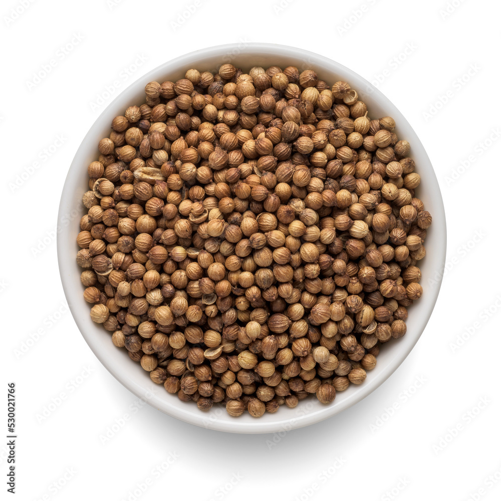 Dry coriander seeds in round bowl isolated on white. Top view. Dry coriander seeds in round bowl isolated on white. Top view.