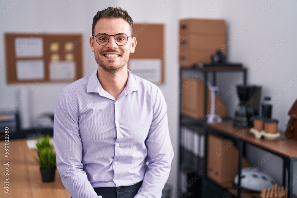 Young hispanic man at the office with a happy and cool smile on face. lucky person. Young hispanic man at the office with a happy and cool smile on face. lucky person.