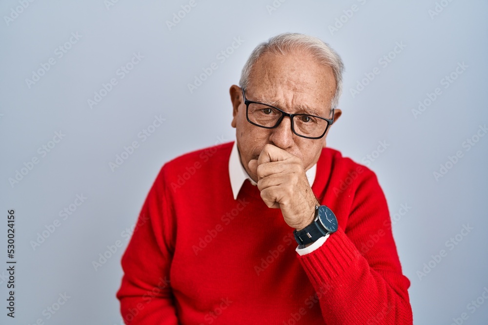Senior man with grey hair standing over isolated background feeling unwell and coughing as symptom for cold or bronchitis. health care concept.