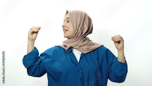 The hijab woman is very angry at what happened. Indoor studio shot isolated on white background. The woman is making fun of the interlocutor by making gestures or something. photo