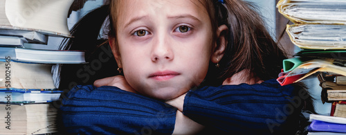 Angry and skeptical young business girl working overtime alone in office without cariere perspective and additional payments. Horizontal image. photo