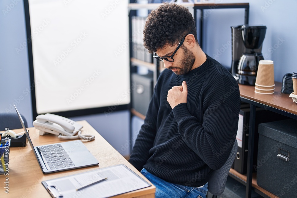 Young arab man business worker suffering for chest pain at office Young arab man business worker suffering for chest pain at office