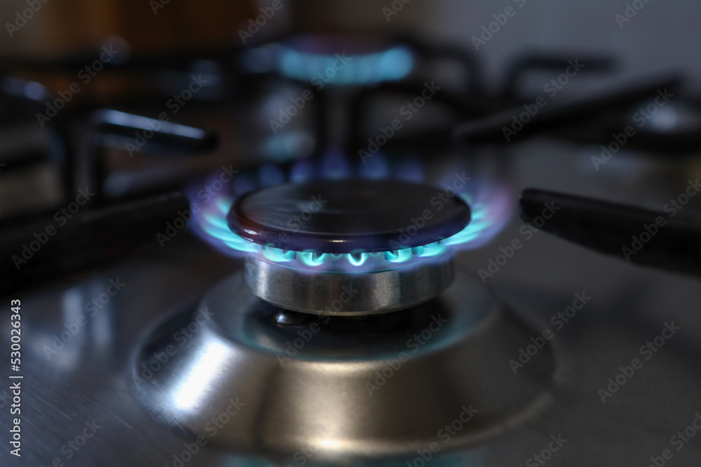 Close-up of a flame of methane gas stove in a domestic kitchen Close-up of a flame of methane gas stove in a domestic kitchen