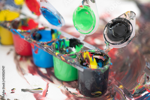 Hand painting on paper from color containers. Mixing colors