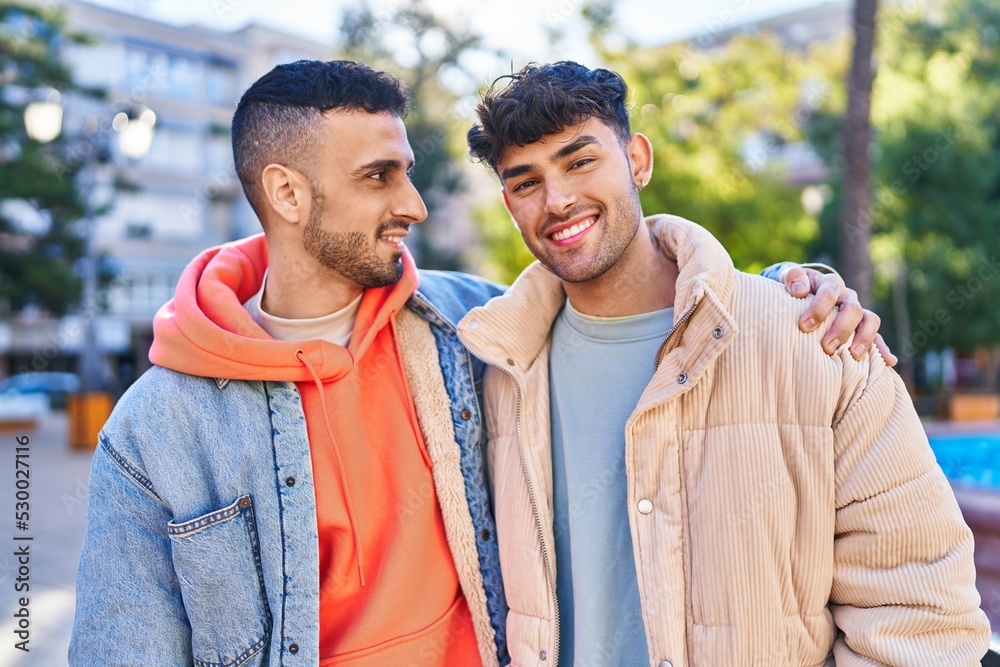 Two man couple hugging each other standing at park Two man couple hugging each other standing at park