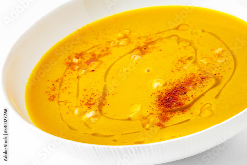 Fragrant first course from corn and paprika. Vegetarian dietary cream soup based on baked and fresh vegetables with herbs. Fitness menu. Delivery of prepared food. White background