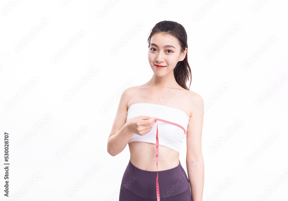 Attractive women in white sports underwear measure their breasts Attractive women in white sports underwear measure their breasts