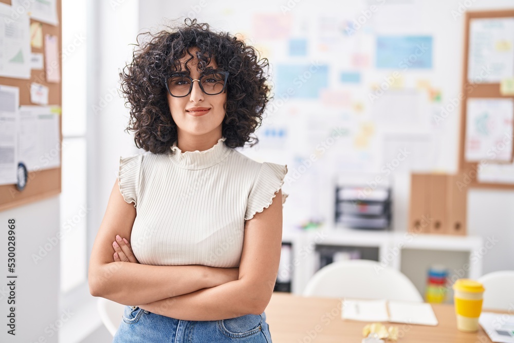 Young middle eastern woman business worker smiling confident standing with arms crossed gesture at office Young middle eastern woman business worker smiling confident standing with arms crossed gesture at office