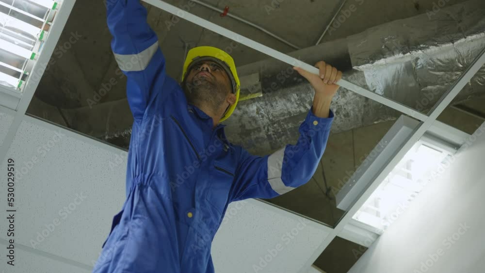 Professional electrician installer at work, Builder with installation ...