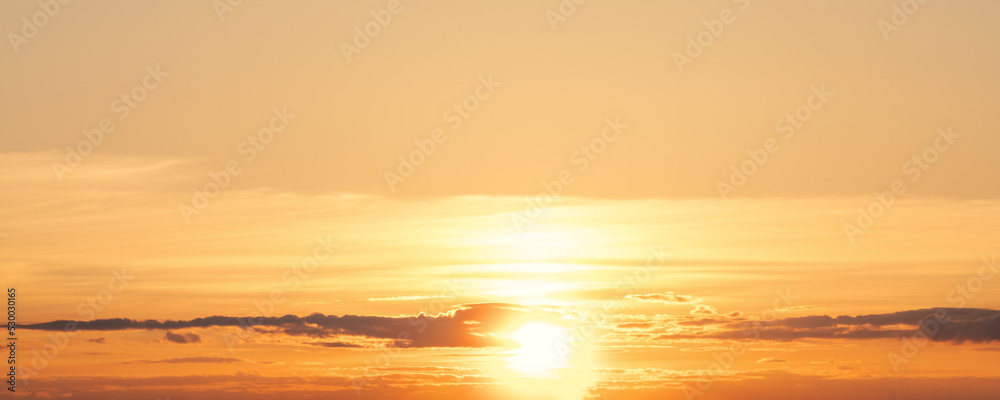 Yellow and orange colored sky background with bright sun bowl panoramic view at sunset