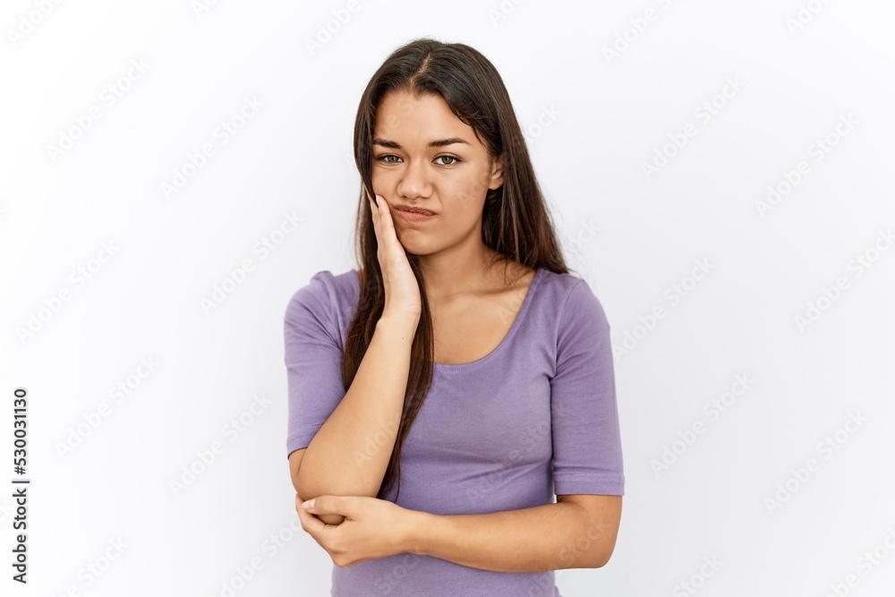 Young brunette woman standing by isolated background thinking looking tired and bored with depression problems with crossed arms. Young brunette woman standing by isolated background thinking looking tired and bored with depression problems with crossed arms.