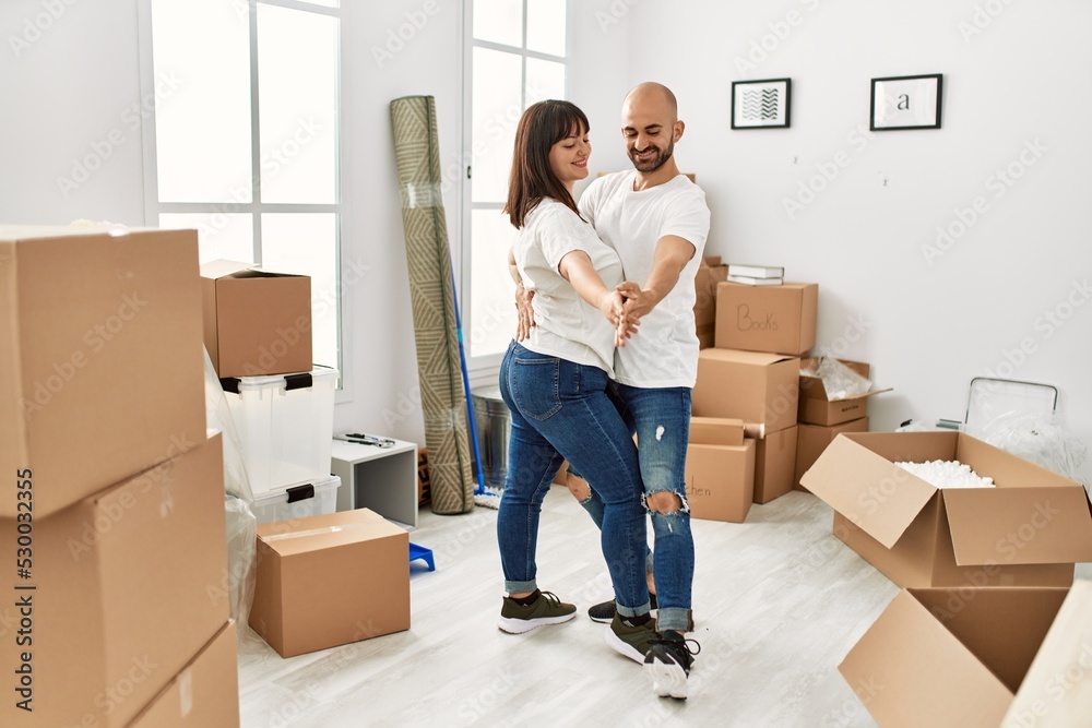 Young hispanic couple smiling happy dancing at new home. Young hispanic couple smiling happy dancing at new home.