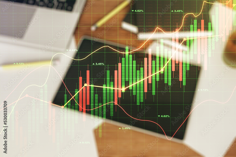 Multi exposure of abstract financial graph and modern digital tablet on desktop on background, top view, financial and trading concept Multi exposure of abstract financial graph and modern digital tablet on desktop on background, top view, financial and trading concept