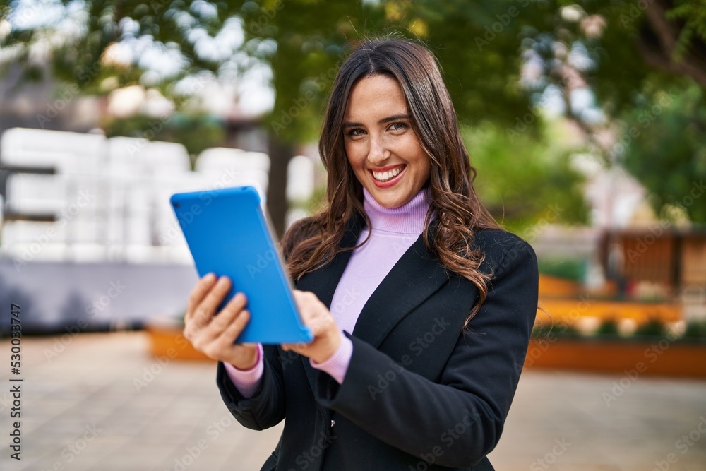 Young hispanic woman smiling confident using touchpad at park Young hispanic woman smiling confident using touchpad at park