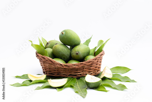 Fresh Green Raw Mango Also Called Aam, Kairi In Tradition Indian Wooden Basket Has Multiple Health Benefits, Is Rich Source Of Vitamins. Used For Chutney, Khatta Aam Panna And Aam Ka Achar Pickle